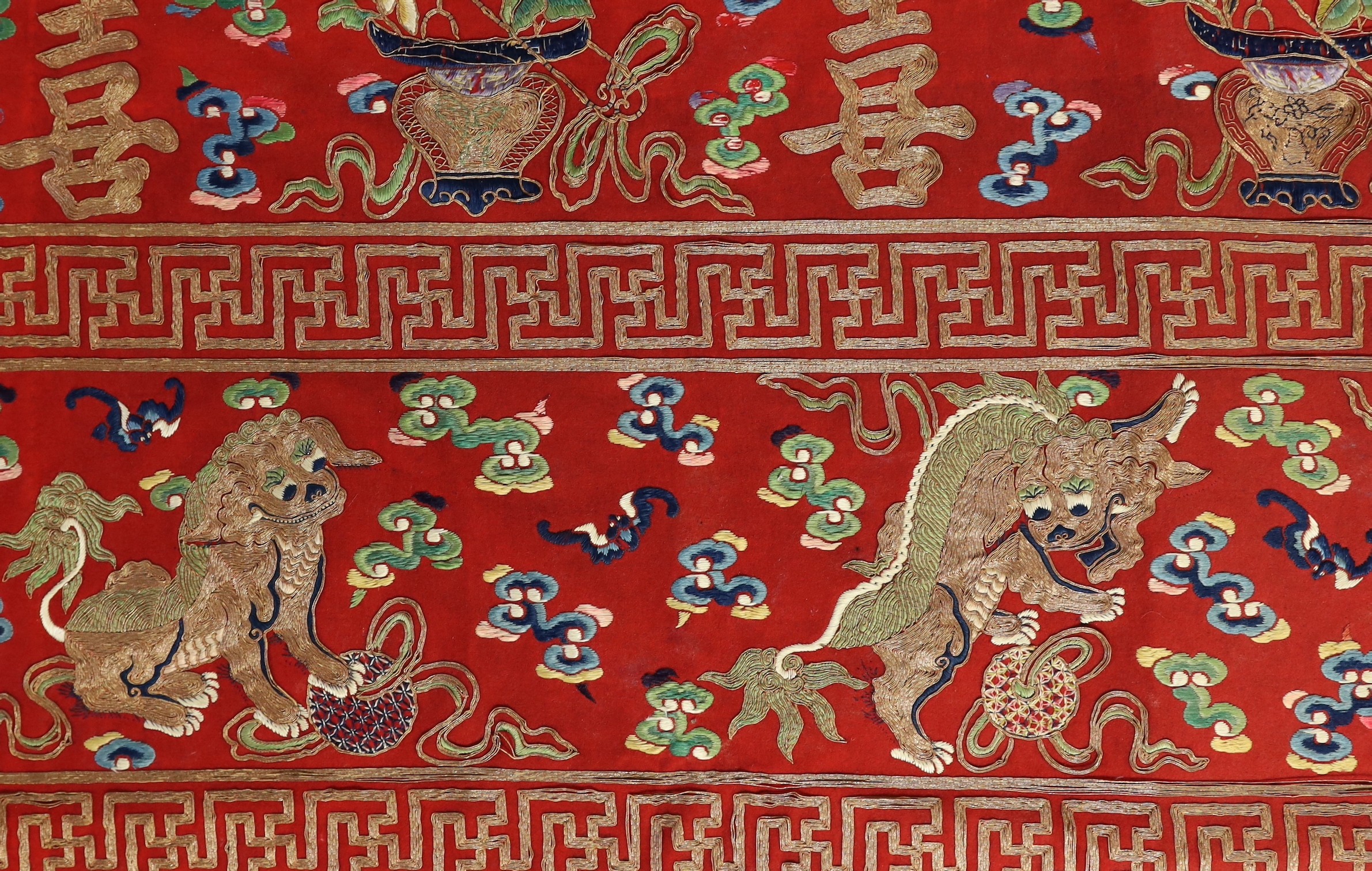 A Chinese embroidered silk ‘dragon, phoenix and lion’ panel or table frontal, late Qing dynasty, 117cm x 337cm